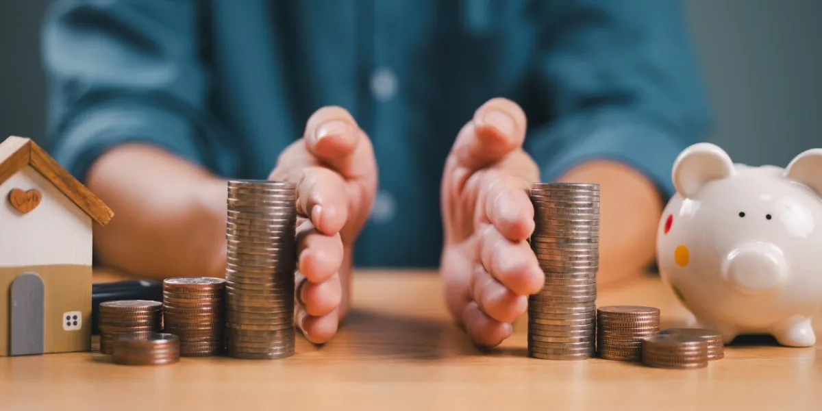 divorce law and inheritance separation concept hand separate saving money, finance, home loan, debt return with piggybank and wood house bank business investment man separate stack coin on table