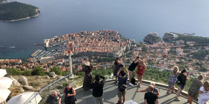 tourists take selfies with a panoramic view of dubrovnik on september 13, 2018 (photo by daniel slim   afp)