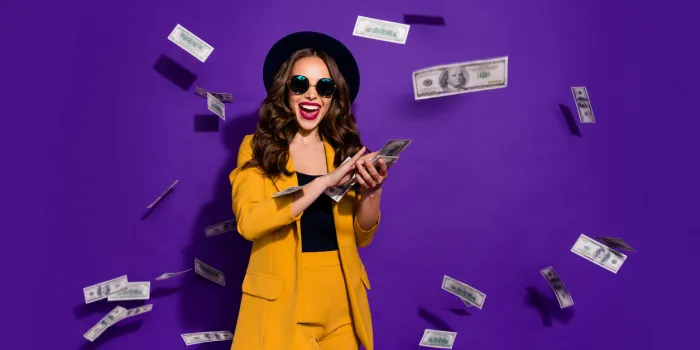 portrait of her she nice attractive cheerful cheery positive trendy luxury, wavy-haired lady throwing 100 hundred million expenses isolated over bright vivid shine violet lilac background