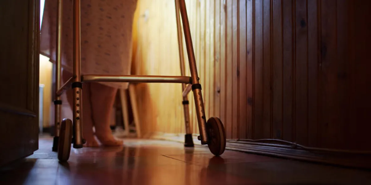 elderly womans feet walking at home with aid of walker difficulty of life in old age