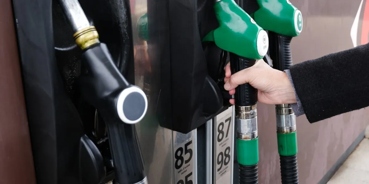 hand taking the unleaded gun 95 in close-up