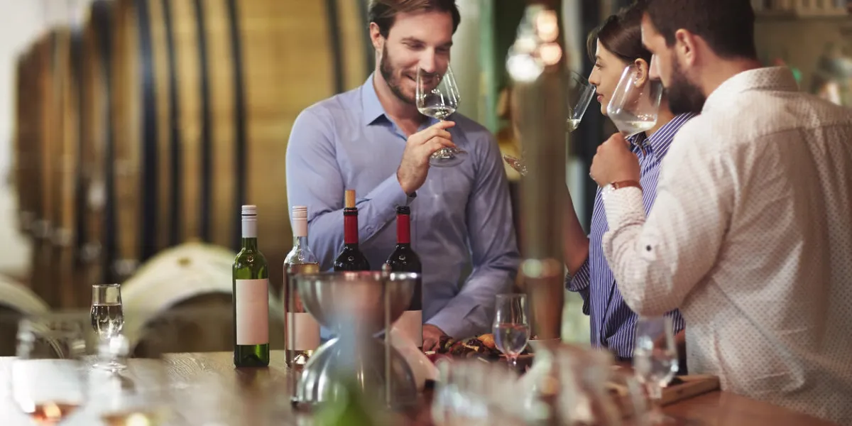 heterosexual couple tasting white wine in the winery during degustation