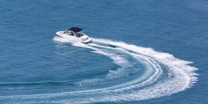 recreational high speed motorboat makes sudden turn at sea