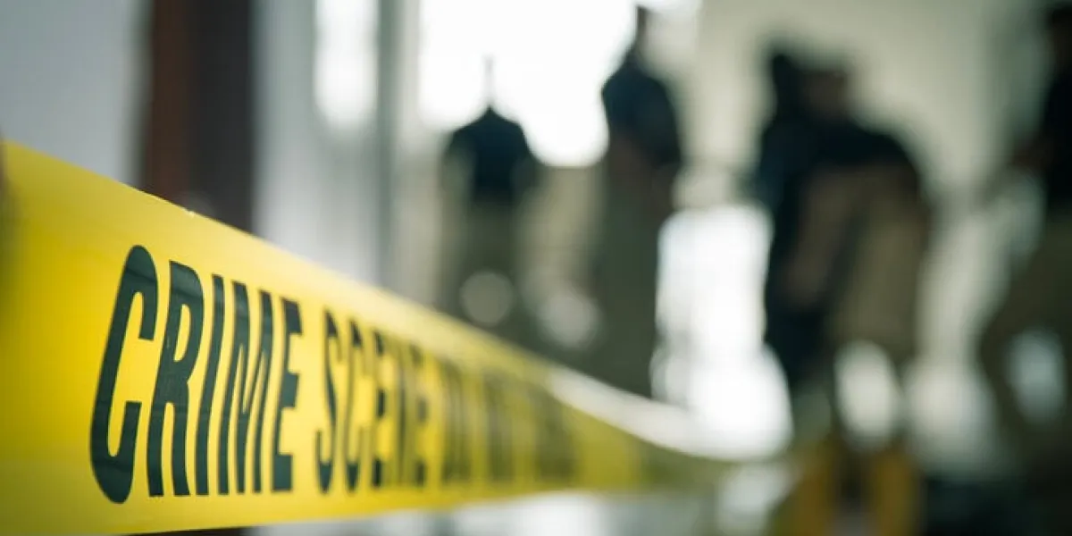 crime scene tape with blurred forensic law enforcement background in cinematic tone and copy space