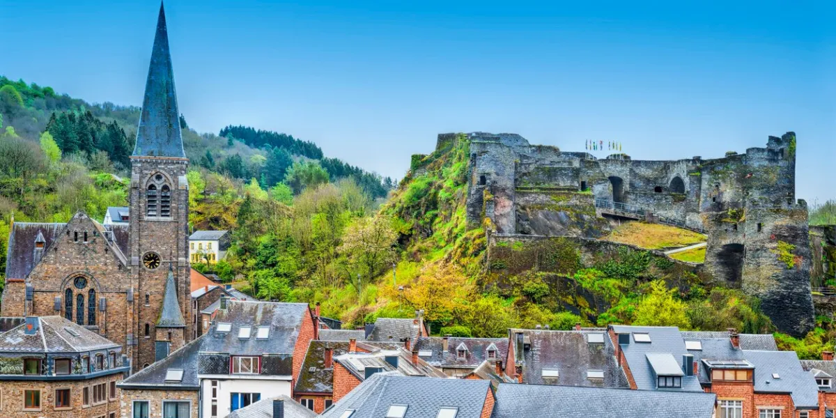 view of the church and the castle in the belgian city of la roche view of the town centre below its medieval castle in of la roche