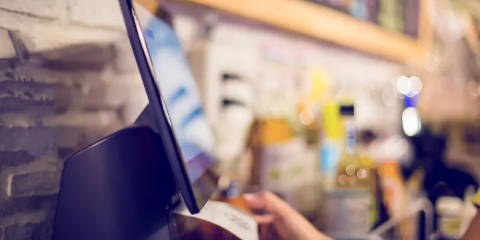 blurry picture of cashier is printing receipt with cash register machine in cafe or store saleswoman receiving payment from customer in cafe or store blurry image for business background
