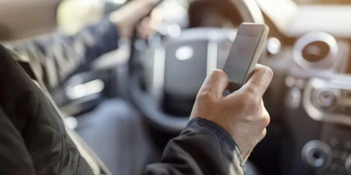 using a phone in a car texting while driving concept for danger of text message and being distracted