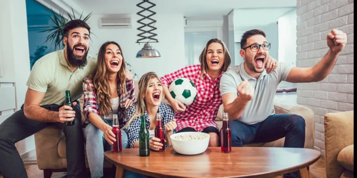 happy friends or football fans watching soccer on tv and celebrating victory at homefriendship, sports and entertainment concept