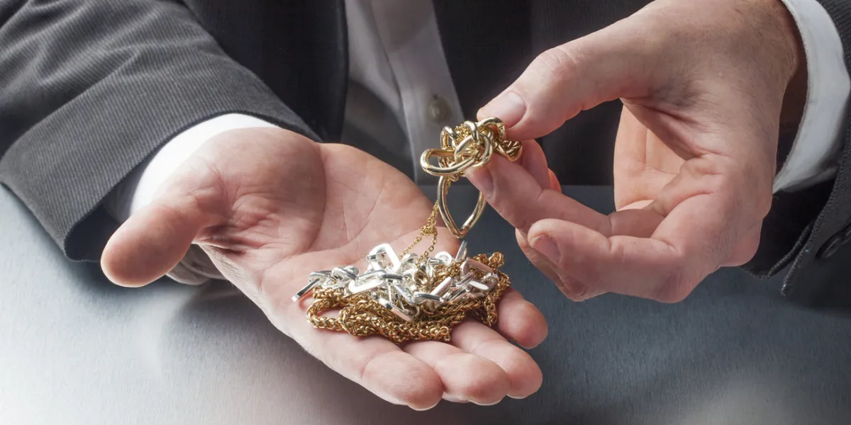 golden and silver jewellery in hands