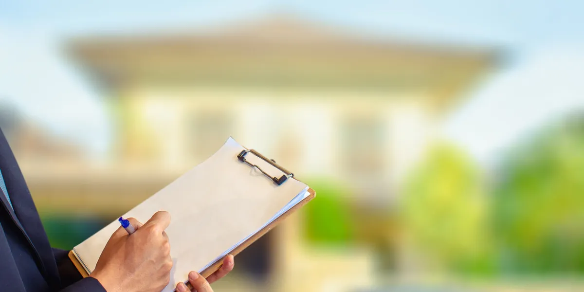 man business salesman sell house with computer on house and tree blurry backgroundfor home business contracting or agreement and home warranty image