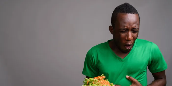studio shot of young african man against gray background horizontal shot