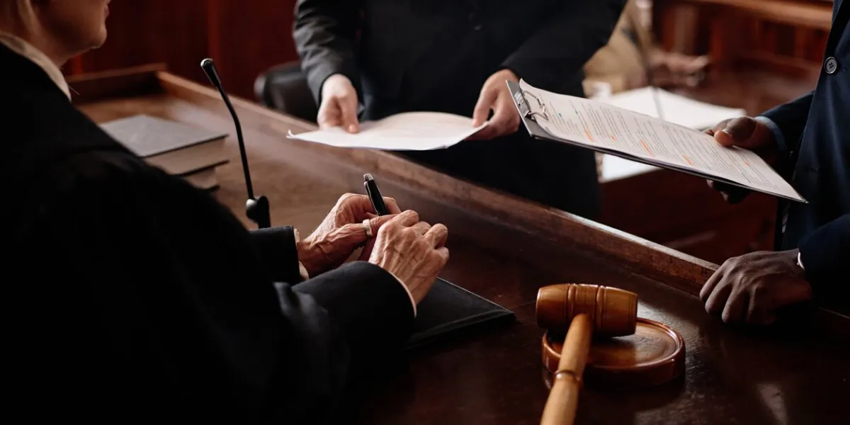 close-up of accusation and protection sides with juridical documents standing in front of female judge during discussion of case points