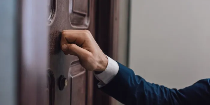 cropped view of collector knocking on door with hand