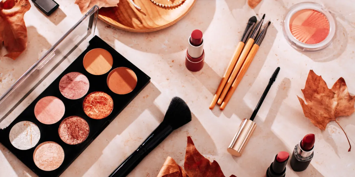 beauty products and makeup, autumn leaves on beige background autumn skincare and autumn makeup concept