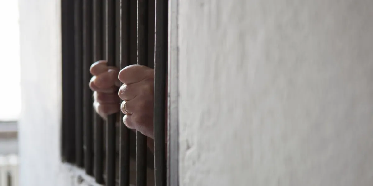 man behind prison bars