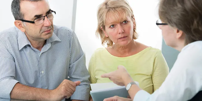 couple getting financial advice from consultant at home