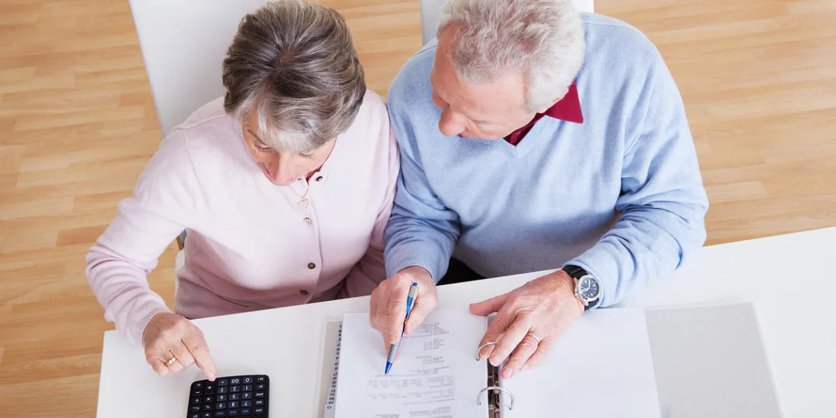 photo of senior couple calculating budget at home