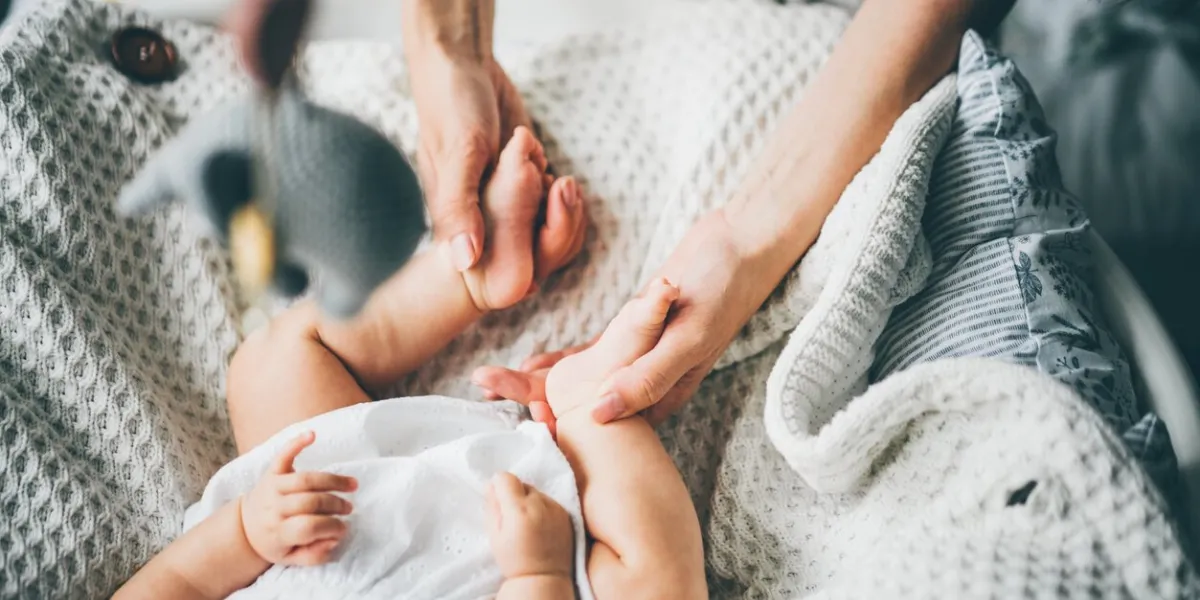 baby feet in mother hands mom and her daughter happy family concept conceptual image of maternity
