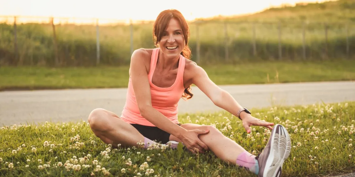 a nice woman practicing stretching at the sunset