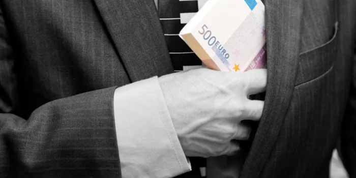 man hides in a suit jacket pocket a bundle of banknotes 500 euros