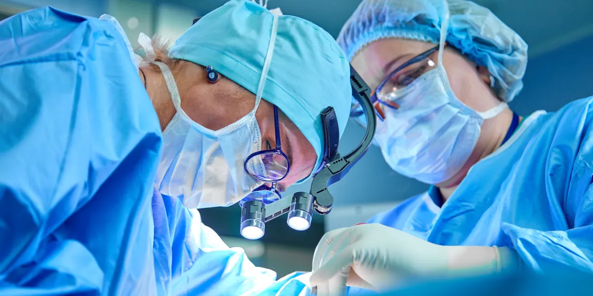 a surgeon's team in uniform performs an operation on a patient at a cardiac surgery clinic modern medicine, a professional team of surgeons, health