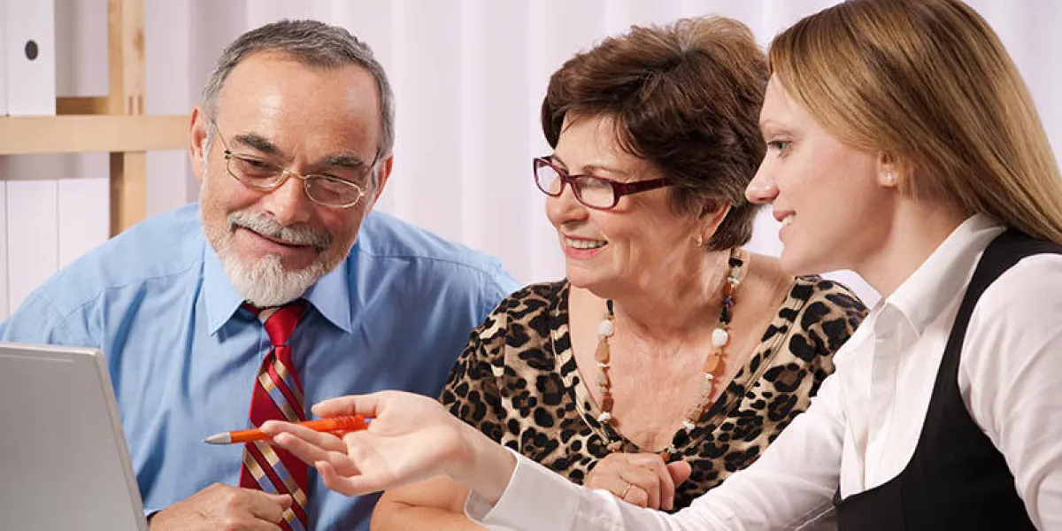 senior couple meeting with agent or advisor