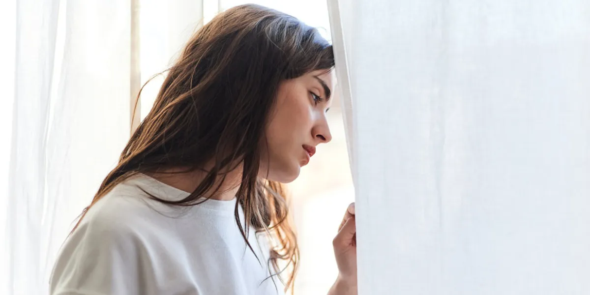 sad young woman crying in her bedroom at home mental health concept