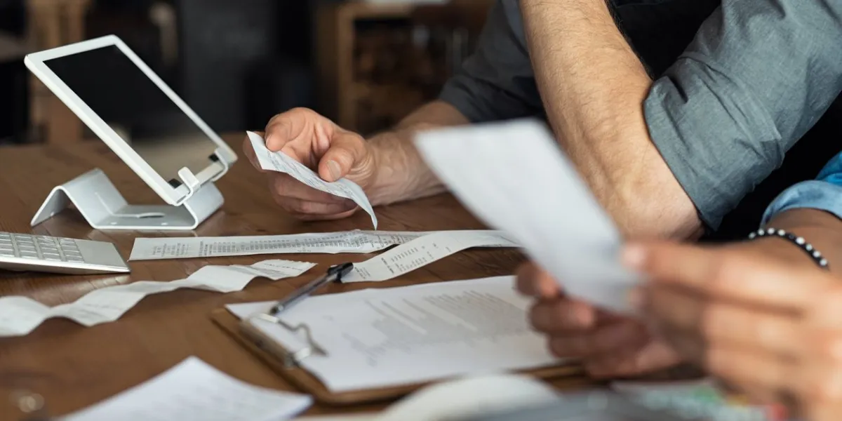 mature smalll business owners calculating finance bills of their activity business people using calculator to work closeup hands of man and woman calculating bills and expenses