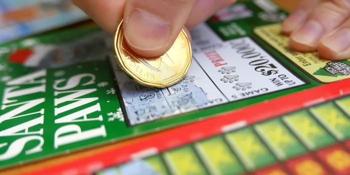 coquitlam bc canada - january 24, 2015   woman scratching lottery tickets the british columbia lottery corporation has provided government sanctioned lottery games in british columbia since