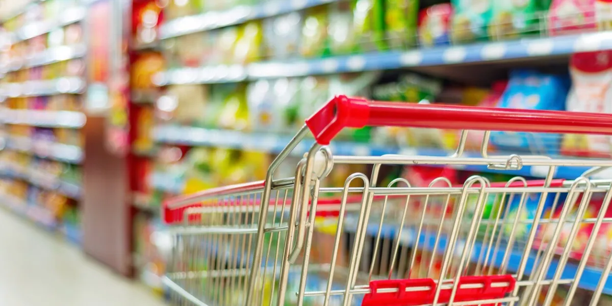 supermarket interior, empty red shopping cart