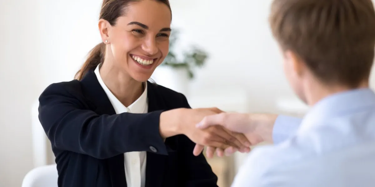 head shot happy female mixed race human resources manager shaking hands with job applicant on interview smiling businesswoman welcoming new partner on meeting pleasant advisor greeting client