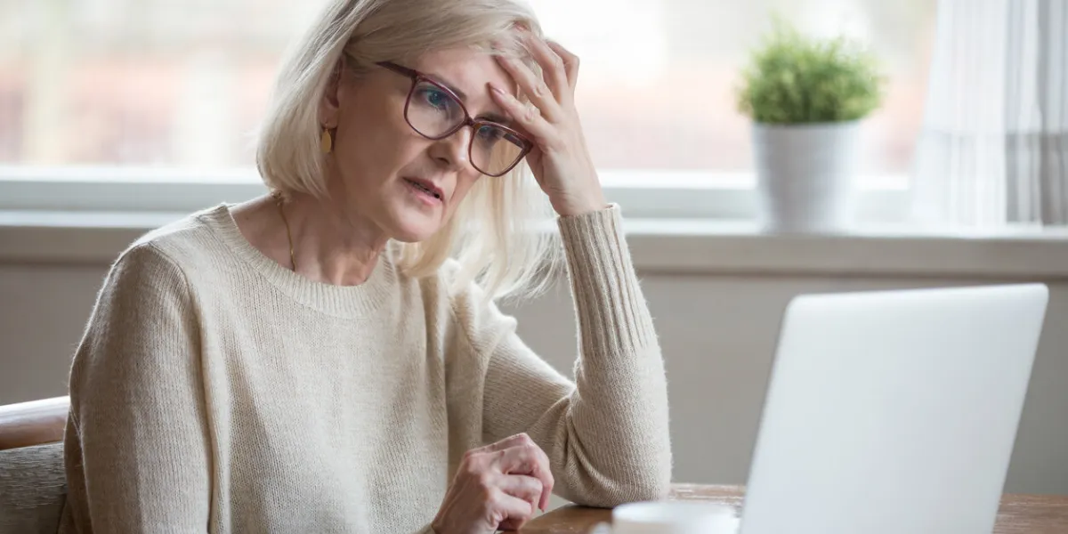 thoughtful confused mature business woman concerned thinking about online problem looking at laptop, frustrated worried senior middle aged female reading bad email news, suffering from memory loss