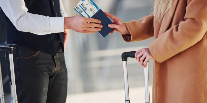 close up view of woman that gives tickets to security man in airport