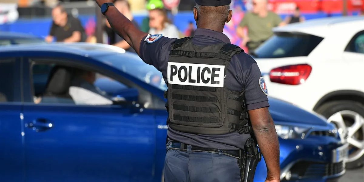 paris, france-10 10 2023  police officer regulating car traffic place de la concorde in paris, france