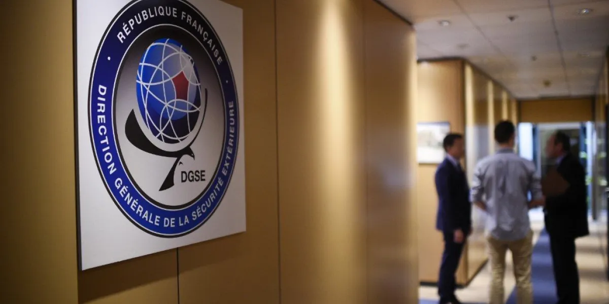 three men speak in a corridor at the headquarters of the general directorate for external security (dgse), france's external intelligence agency, in paris on june 4, 2015 afp photo   martin bureau (photo by martin bureau   afp)