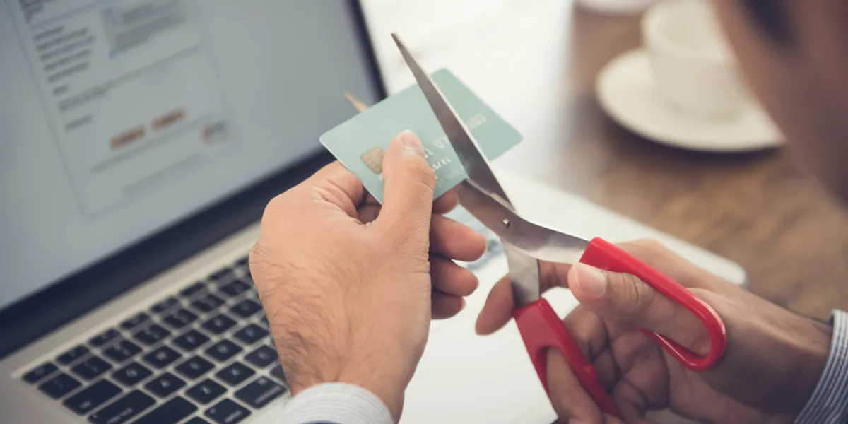 businessman cutting a credit card that canceled by financial institute due to negligent usage