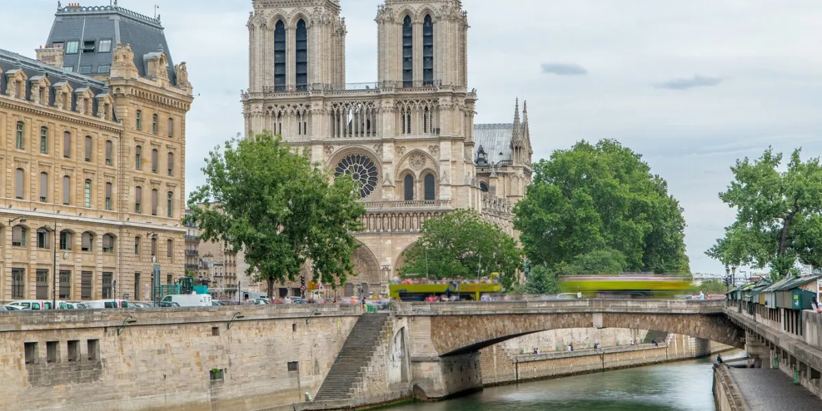 notre dame de paris timelapse one of the most famous symbols of paris petit bridge - cardinal lustiger view from bridge of saint-michel with boats on river at sunny summer day