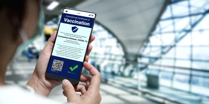 traveler holds vaccine passport certificate to show covid 19 vaccination status the digital health certificate is required for international travel during coronavirus pandemic
