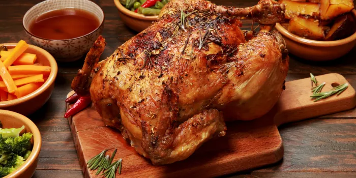 roast chicken and vegetables on a wooden table