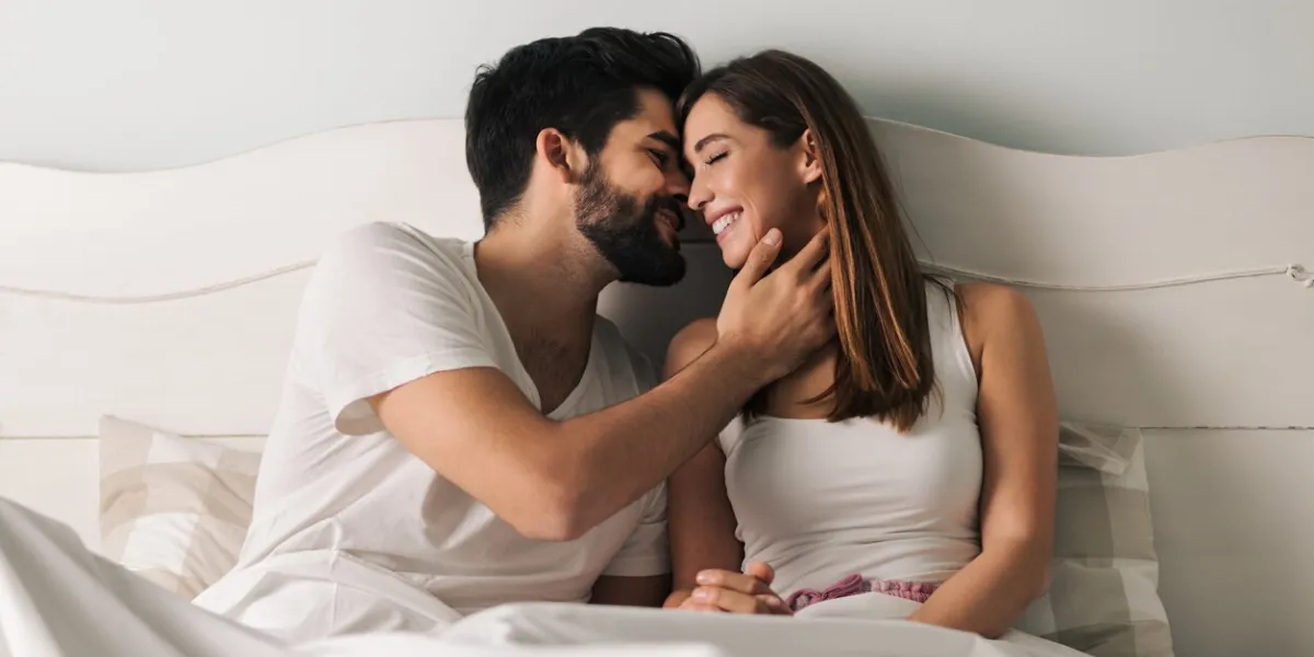 affectionate young couple relaxing in bed and having a romantic moment