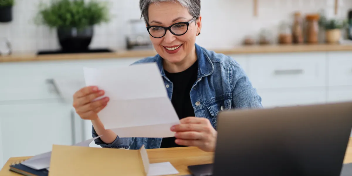 happy woman holding paper with good news, payout