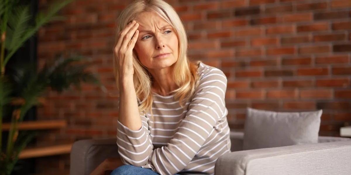 portrait of a tired business woman headache in an older person mistakes and problems at work