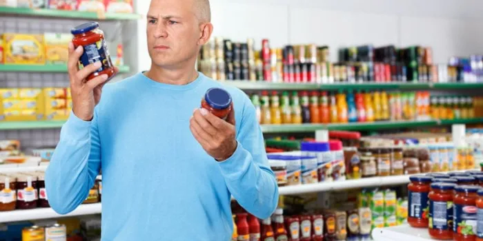 focused glad cheerful positive man choosing fresh products during shopping at food store