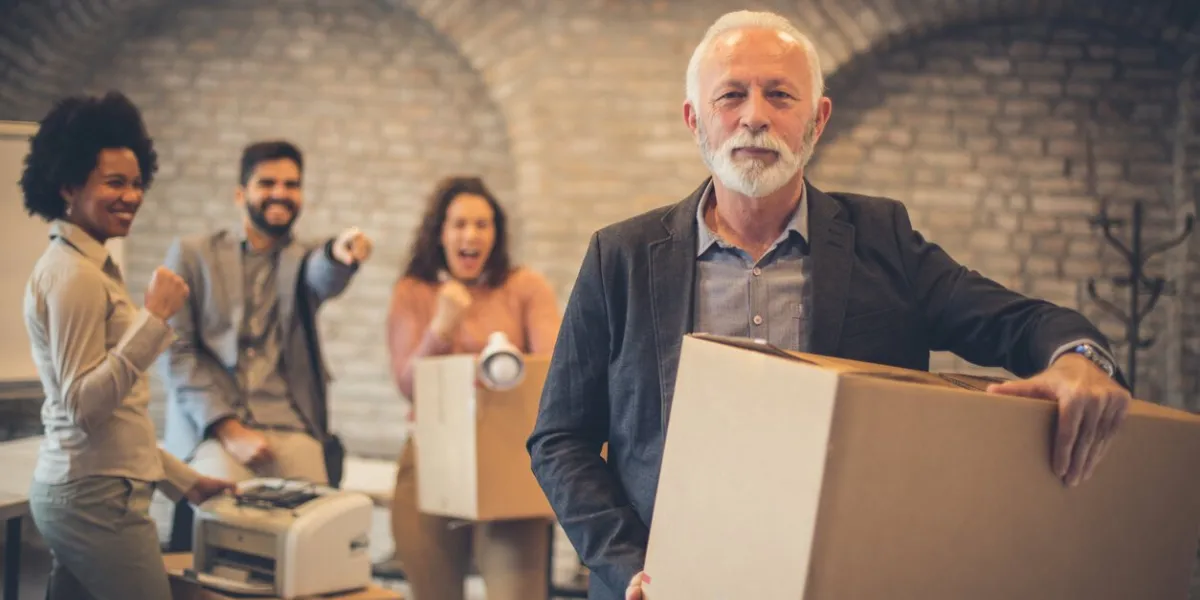 my departure from work gives them pleasure businesspeople talking in the office focus on man two plans looking at camera