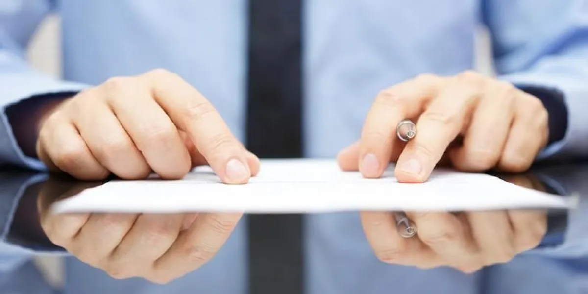 businessman is carefully reading contract