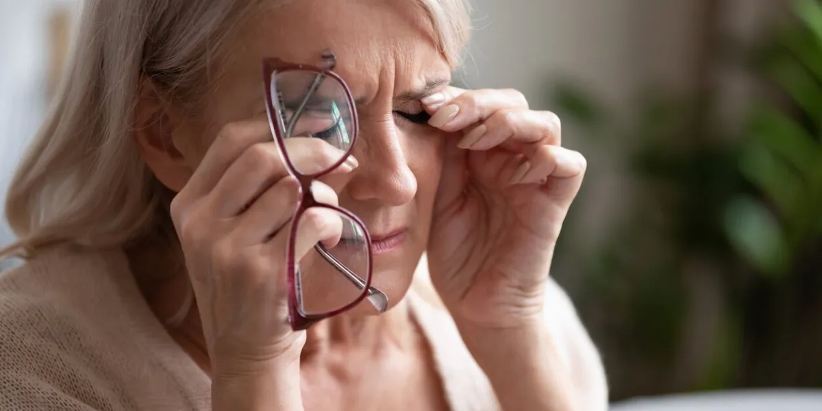 tired older woman taking off glasses, feeling eye strain, touching eyelids close up, unhappy exhausted mature female suffering from dry eyes syndrome, vision health problem concept