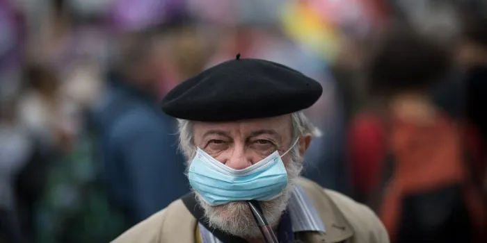 a man smokes a pipe while wearing a face mask during a  demonstration in nantes, western france, on june 30, 2020, as part of a nationwide day of protests to demand better working conditions for health workers (photo by loic venance   afp)