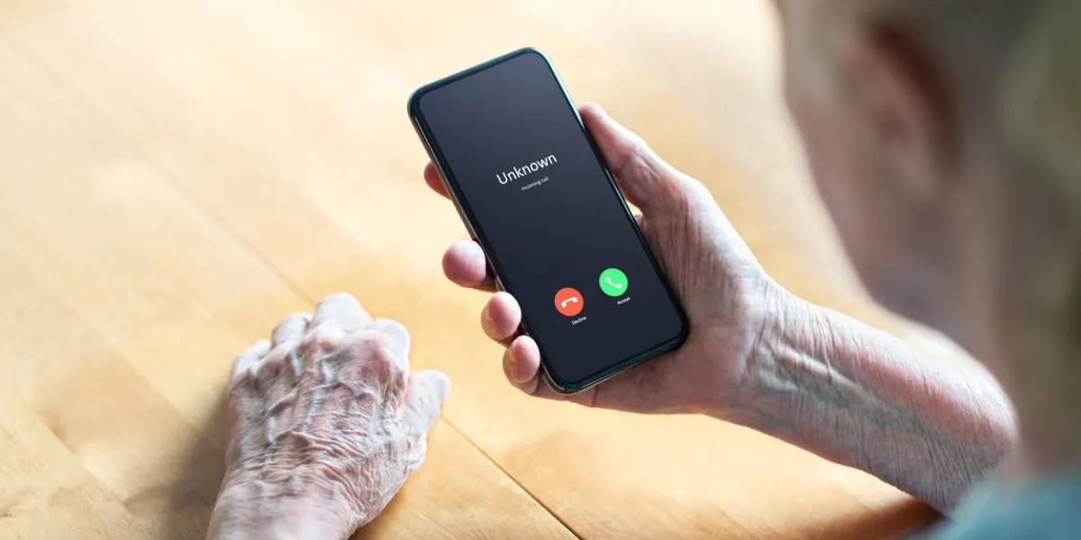 phone call to old woman from scam or fraud caller elder senior answering to unknown number smartphone scammer or mobile hoax, catfish or phishing concept stalker or stranger grandma with cellphone
