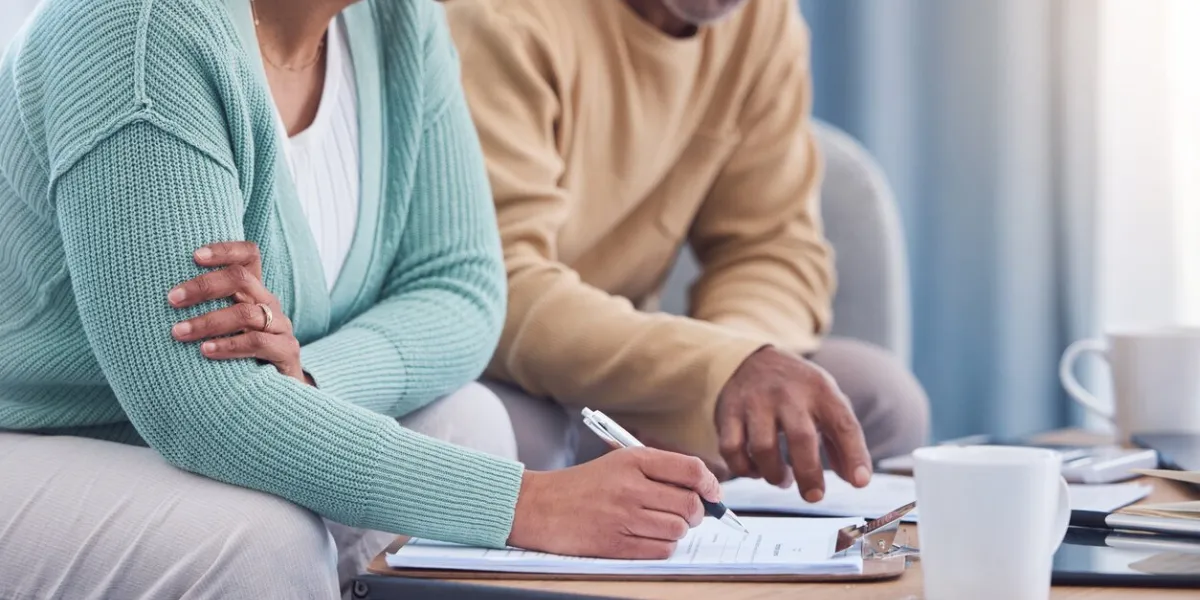 senior couple, documents and sign contract for life insurance or home mortgage discussion, signature and retired elderly man and woman signing legal paperwork for will or loan application together