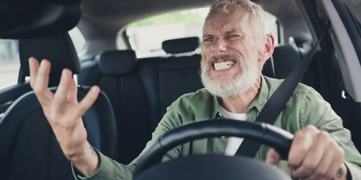 photo of irritated annoyed seniour guy wear green shirt driving car shouting outdoors urban city street